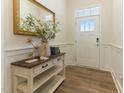 Welcoming entryway with stylish console table, decorative mirror, and attractive front door at 1 Parker Pond Ct, Durham, NC 27703