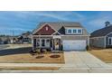 Charming single-Gathering home with gray siding, brick accents, and a well-maintained front yard with landscaping at 1 Parker Pond Ct, Durham, NC 27703