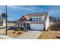 Charming home with a two-car garage, stone accents, and manicured front yard at 1 Parker Pond Ct, Durham, NC 27703