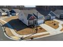 Aerial view showcasing the side of a two-car garage home and the corner lot at 1 Parker Pond Ct, Durham, NC 27703