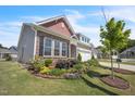 Charming home showcasing stone accents, and a landscaped yard at 1 Parker Pond Ct, Durham, NC 27703