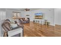 Bright living room with hardwood floors, fireplace, and cozy seating area at 10 Holden Ct, Youngsville, NC 27596