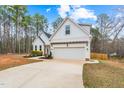 Beautiful exterior with a two-car garage, enhanced by lush landscaping and a well-maintained driveway at 105 Shawnee Drive, Louisburg, NC 27549