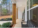 Covered porch with wooden pillars with bench seating and a welcoming atmosphere at 105 Shawnee Drive, Louisburg, NC 27549