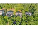 Aerial view of the property showing the home's location surrounded by mature trees with estimate property lines at 108 Branchside Ln, Holly Springs, NC 27540