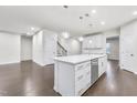 Bright kitchen featuring a large island with seating and sleek stainless steel appliances, flowing into an open-concept living area at 1103 Freestone Rd, Durham, NC 27703