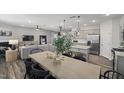 Open-concept dining area with modern decor, adjacent to a kitchen with stainless steel appliances and a cozy living room at 1113 Freestone Rd, Durham, NC 27703