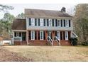 Inviting two-story home with brick accents, gray siding, and a well-maintained front lawn at 112 Hartland Ct, Raleigh, NC 27614