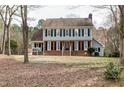Traditional two-story home with a brick facade, complemented by mature trees and landscaping at 112 Hartland Ct, Raleigh, NC 27614
