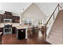 Open kitchen with stainless steel appliances, granite countertops, and hardwood floors at 114 Mt Evans Dr, Durham, NC 27705
