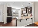 Modern kitchen featuring granite countertops, dark cabinetry, and stainless steel appliances at 114 Mt Evans Dr, Durham, NC 27705