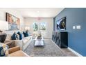 Stylish living room features modern decor, a sleek entertainment center, and an abundance of natural light at 123 Holmes Corner Dr, Smithfield, NC 27577