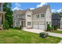 Charming two story home boasts a two car garage and well maintained front lawn at 12912 Grey Willow Dr, Raleigh, NC 27613