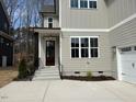 Inviting front entrance with a dark wood door and well-maintained landscaping at 12912 Grey Willow Dr, Raleigh, NC 27613