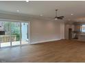 Bright open-concept living room with hardwood floors and sliding doors to deck at 12912 Grey Willow Dr, Raleigh, NC 27613