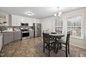 Eat-in kitchen with stainless steel appliances, white cabinets, and a breakfast table at 166 Hammerstone Dr, Fuquay Varina, NC 27526