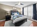 Cozy main bedroom with a king bed, bedside lamps, and large window with natural light at 166 Hammerstone Dr, Fuquay Varina, NC 27526