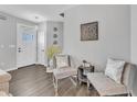 Inviting foyer with modern decor, light gray walls, beautiful flooring and stylish seating at 173 E Wilson St, Clayton, NC 27520