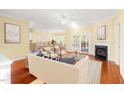 Bright and airy living room featuring hardwood floors, fireplace, and access to a dining area at 2 Poplar Ave, Elon, NC 27244