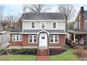 Charming two-story brick home with a manicured front yard at 201 W Trinity Ave, Durham, NC 27701