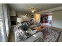 Comfortable living room with a gray sectional, brick fireplace, and ample natural light at 203 Oak Tree Dr, Chapel Hill, NC 27517