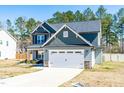 Beautiful two-story home featuring a two-car garage and a well-maintained front yard at 238 Ashpole Trail Trl, Clayton, NC 27520