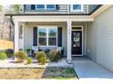 Inviting front porch with seating area, perfect for relaxing and enjoying the outdoors at 238 Ashpole Trail Trl, Clayton, NC 27520