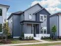 Charming two-story home with a covered porch, gray siding, and modern design at 267 Parkland Dr Dr, Pittsboro, NC 27312