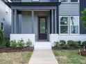 Inviting front porch with painted brick, a modern front door, and well-maintained landscaping at 267 Parkland Dr Dr, Pittsboro, NC 27312