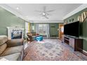 Spacious living room boasts a ceiling fan, fireplace, large window and a patterned area rug at 304 Briarwood Dr, Mebane, NC 27302