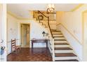 Spacious foyer with hardwood floors, a staircase, and decorative trim at 350 W Lake Trl, Mebane, NC 27302