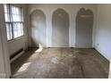 A bedroom with unfinished walls and floors, featuring a window that allows natural light at 4032 Chaucer Dr, Durham, NC 27705