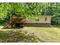 Exterior view of the home with a wooden deck and brick foundation at 441 Wintergreen Rd, Timberlake, NC 27583