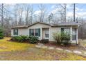 Inviting single-story home featuring a quaint entryway with a stone pathway at 441 Wintergreen Rd, Timberlake, NC 27583