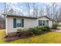 Cozy single-story home with green shutters surrounded by lush greenery at 441 Wintergreen Rd, Timberlake, NC 27583