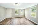 Bright bedroom featuring new wood flooring, light walls and several windows at 501 N 14Th St, Erwin, NC 28339