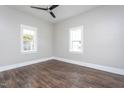 Bright, empty bedroom with hardwood floors, neutral walls, and large windows for natural light at 704 Pender St, Rocky Mount, NC 27801