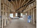 Spacious living room featuring exposed beams, and large windows for natural light at 880 Olive Branch Dr, Smithfield, NC 27577