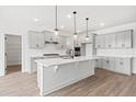 Modern kitchen with gray cabinetry, quartz countertops, island, and stainless steel appliances at 9173 Dupree Meadow Ct # 25, Angier, NC 27501