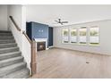 Bright living room with fireplace, large windows, and hardwood floors at 9173 Dupree Meadow Ct # 25, Angier, NC 27501