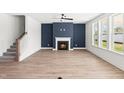Bright living room with fireplace, large windows, and hardwood floors at 9173 Dupree Meadow Ct # 25, Angier, NC 27501