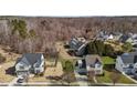 An aerial view of the property showing its location and proximity to neighboring houses and a treed area at 101 Cambridge Way, Oxford, NC 27565