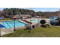 An outdoor swimming pool area with umbrellas and a slide in a Gathering-friendly neighborhood at 101 Cambridge Way, Oxford, NC 27565