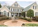 Stately brick home featuring lush landscaping and a brick path leading to the covered front porch at 101 Hedwig Ct, Cary, NC 27518