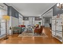 Bright living room with hardwood floors, wainscoting, and stylish furnishings at 101 Settlecroft Ln, Holly Springs, NC 27540