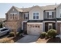 Charming townhomes with stone accents, garages, and well-maintained landscaping create inviting curb appeal at 1013 Rocketcress Dr, Durham, NC 27713