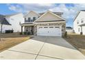 Attractive home with a large two-car garage and an expansive concrete driveway at 105 Hanover Ct, Clayton, NC 27527