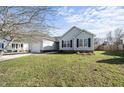Inviting home showcasing a well-manicured lawn and pleasing curb appeal at 112 Theophilous, Holly Springs, NC 27540
