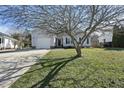 A well-kept home with an attached garage and a green front lawn at 112 Theophilous, Holly Springs, NC 27540