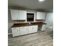 Well-lit kitchen with white cabinetry and wood countertops at 1128 Horseshoe Rd, Durham, NC 27703